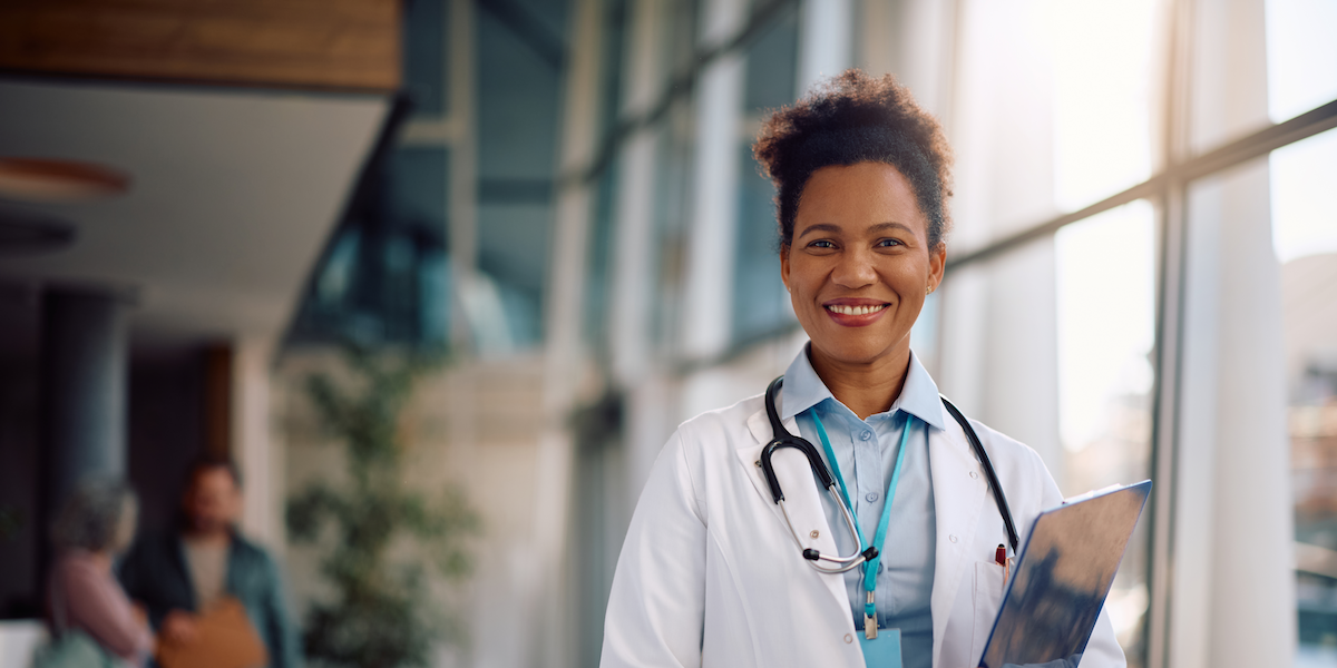 Smiling woman doctor after implementing HR Compliance Platform for Healthcare Industry