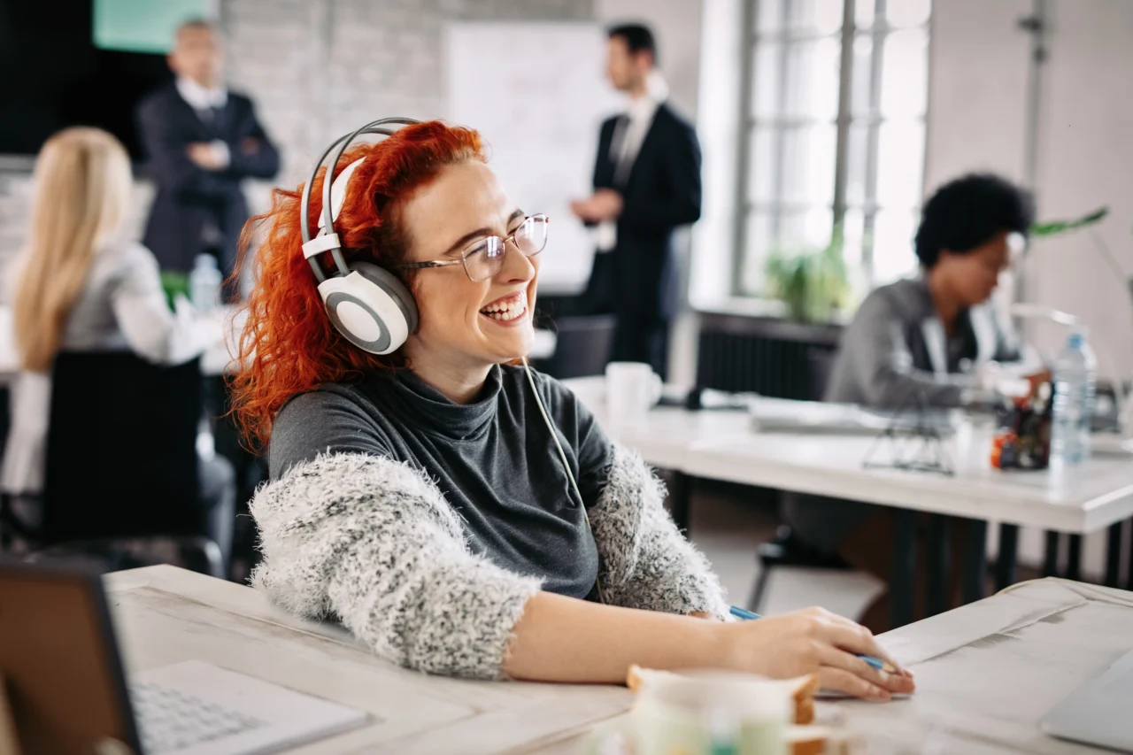 smiling woman with headphones in office